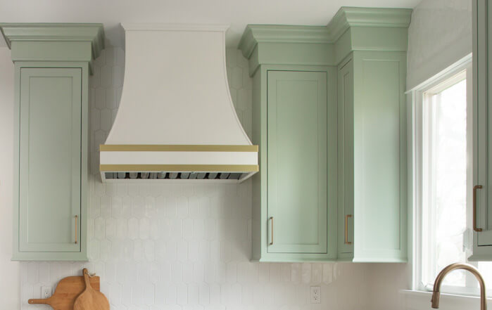 Why would you void a corner with kitchen cabinets? A wall cabinet corner with a voided corner in minty green painted finish and inset cabinet doors.