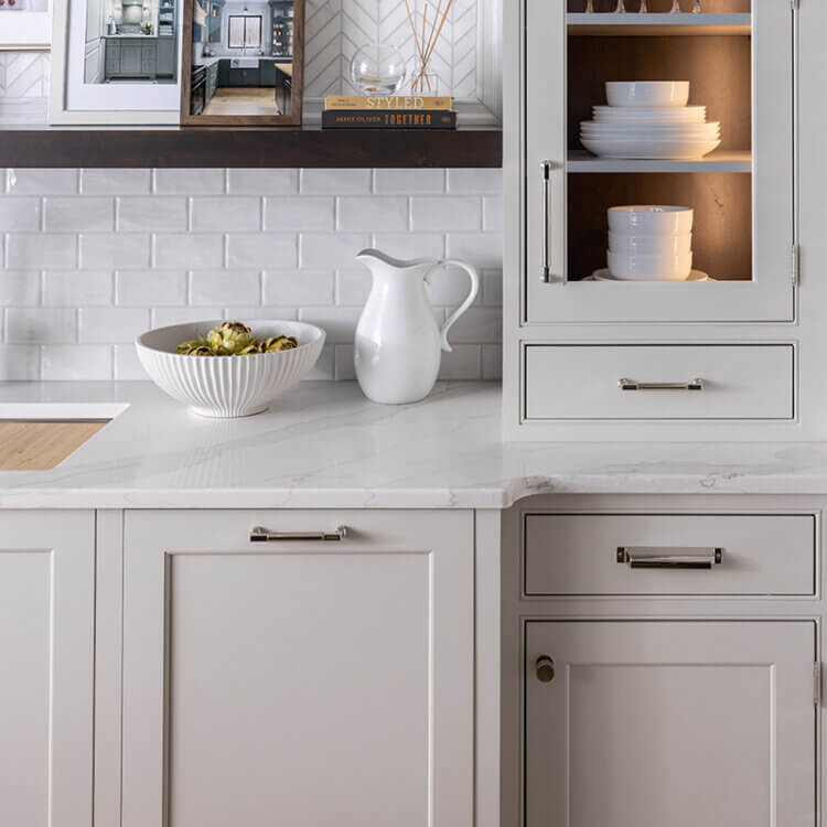 A custom off-white paint color on inset cabinets from Dura Supreme Cabinetry.