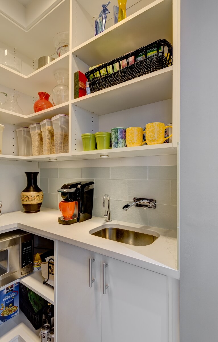 View inside pantry with microwave, sink and storage. Photography by Dennis Jourdan.