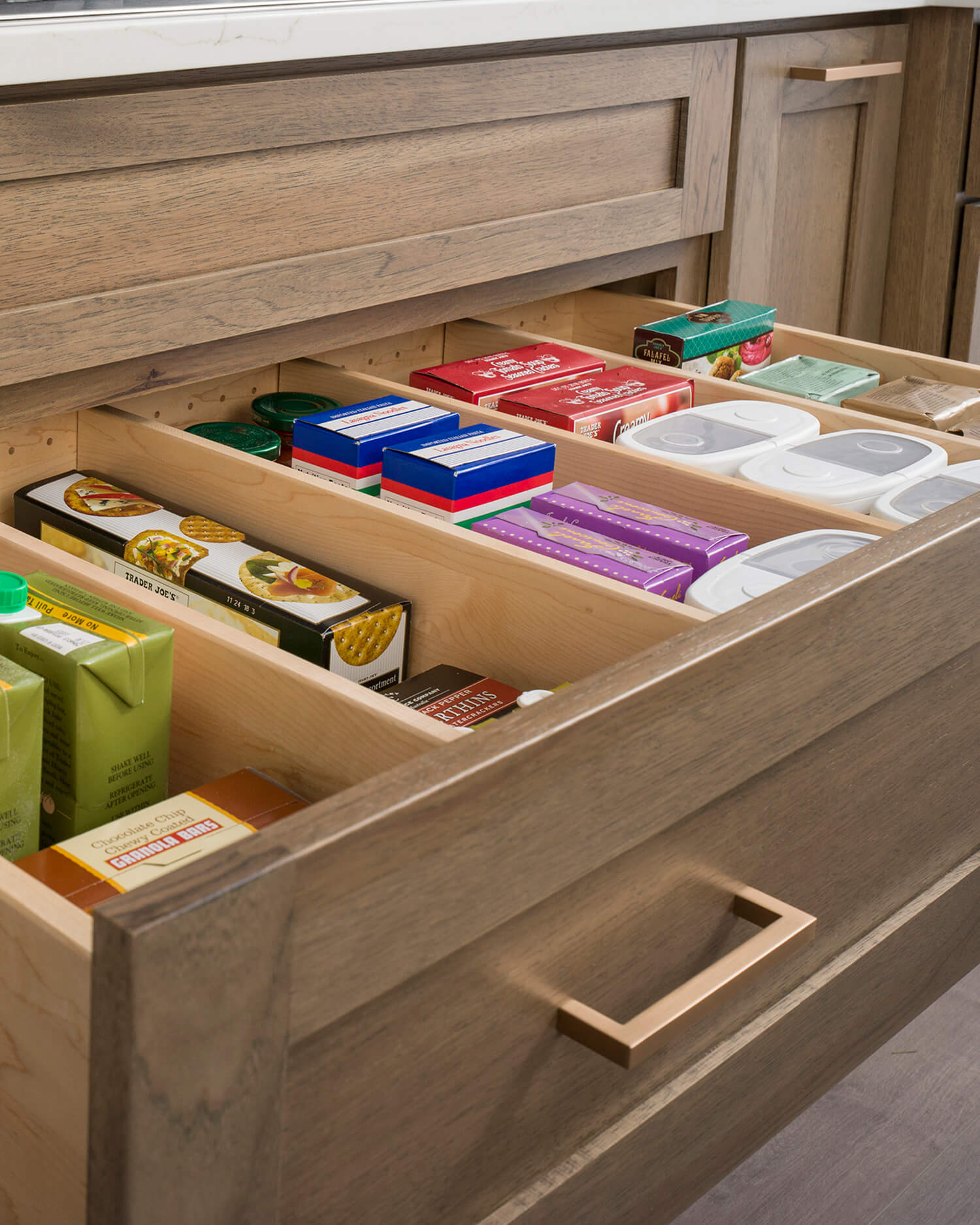 Deep kitchen drawers outfitted with adjustable partitions can create the perfect customizable storage for your pantry goods, bakeware, cookware, and more.