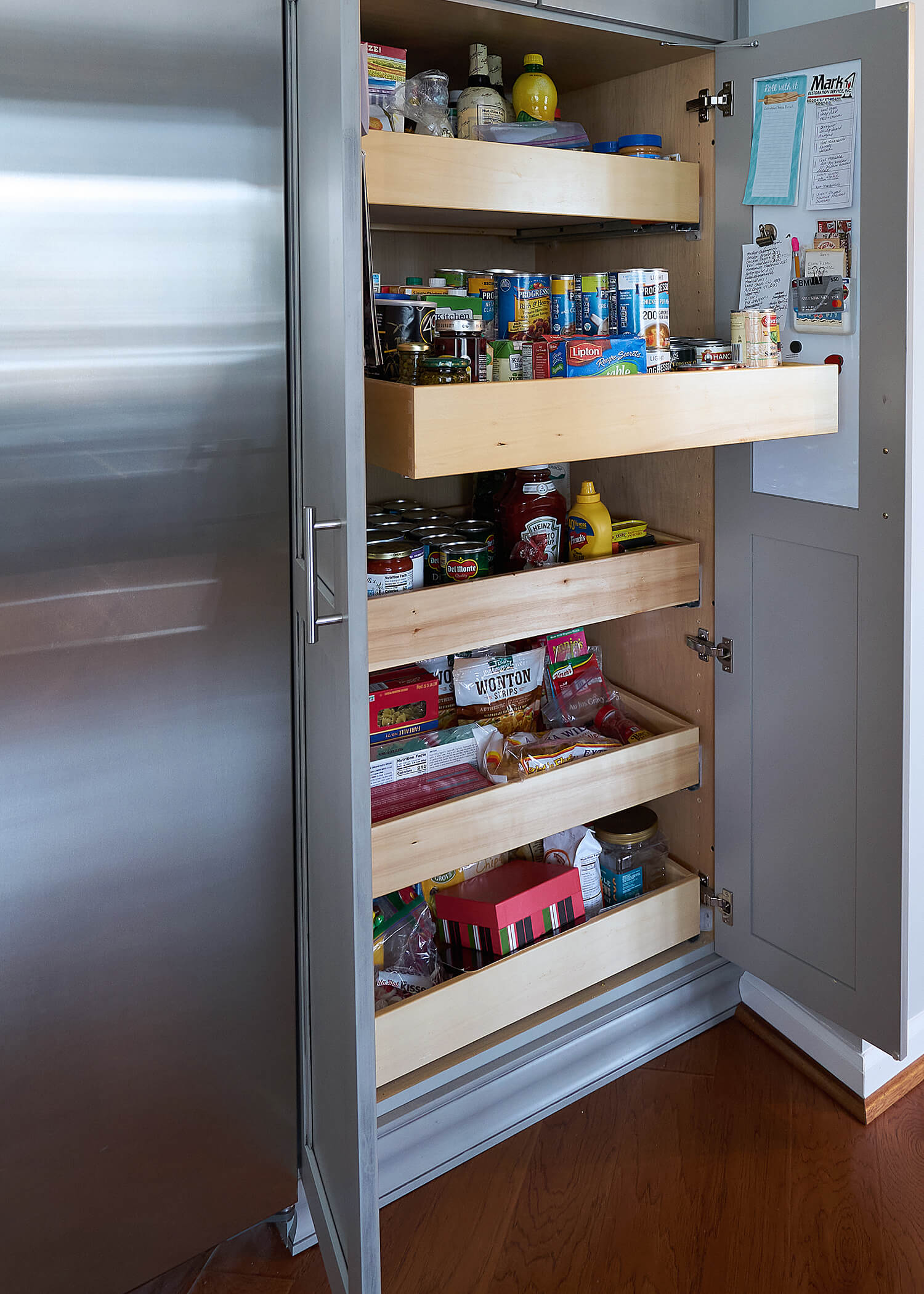 A tall pantry cabinet with Roll-Out Shelves can make your supplies easily accessible.