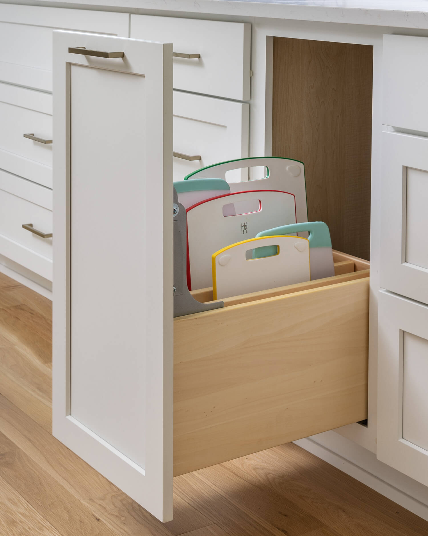 A Base Pull-Out Tray Divider Cabinet from Dura Supreme offers practical and convenient use of space and works great for storing a larger collection of cutting boards, trays, baking sheets, pans, etc.