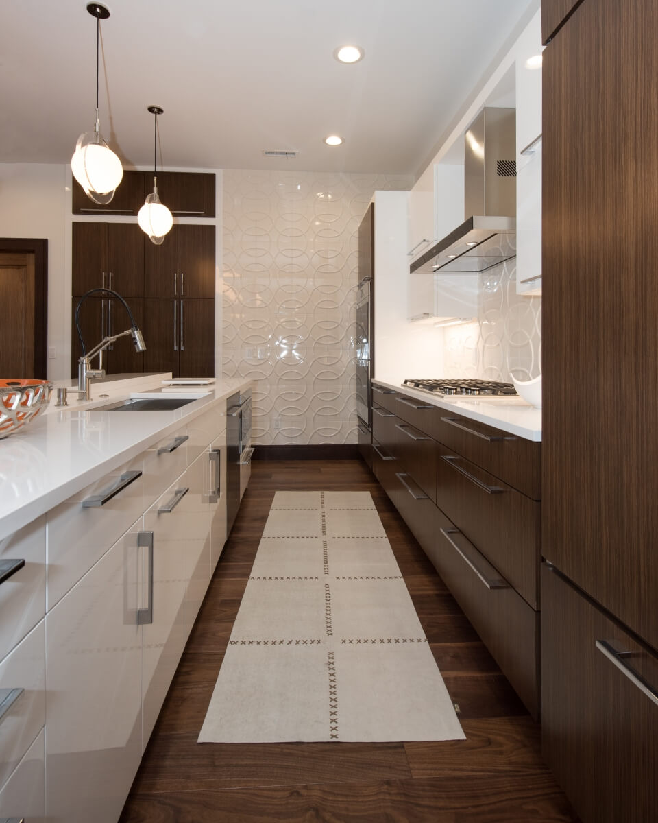 Galley Kitchen Design with a modern style and slab cabinet doors from Dura Supreme Cabinetry.