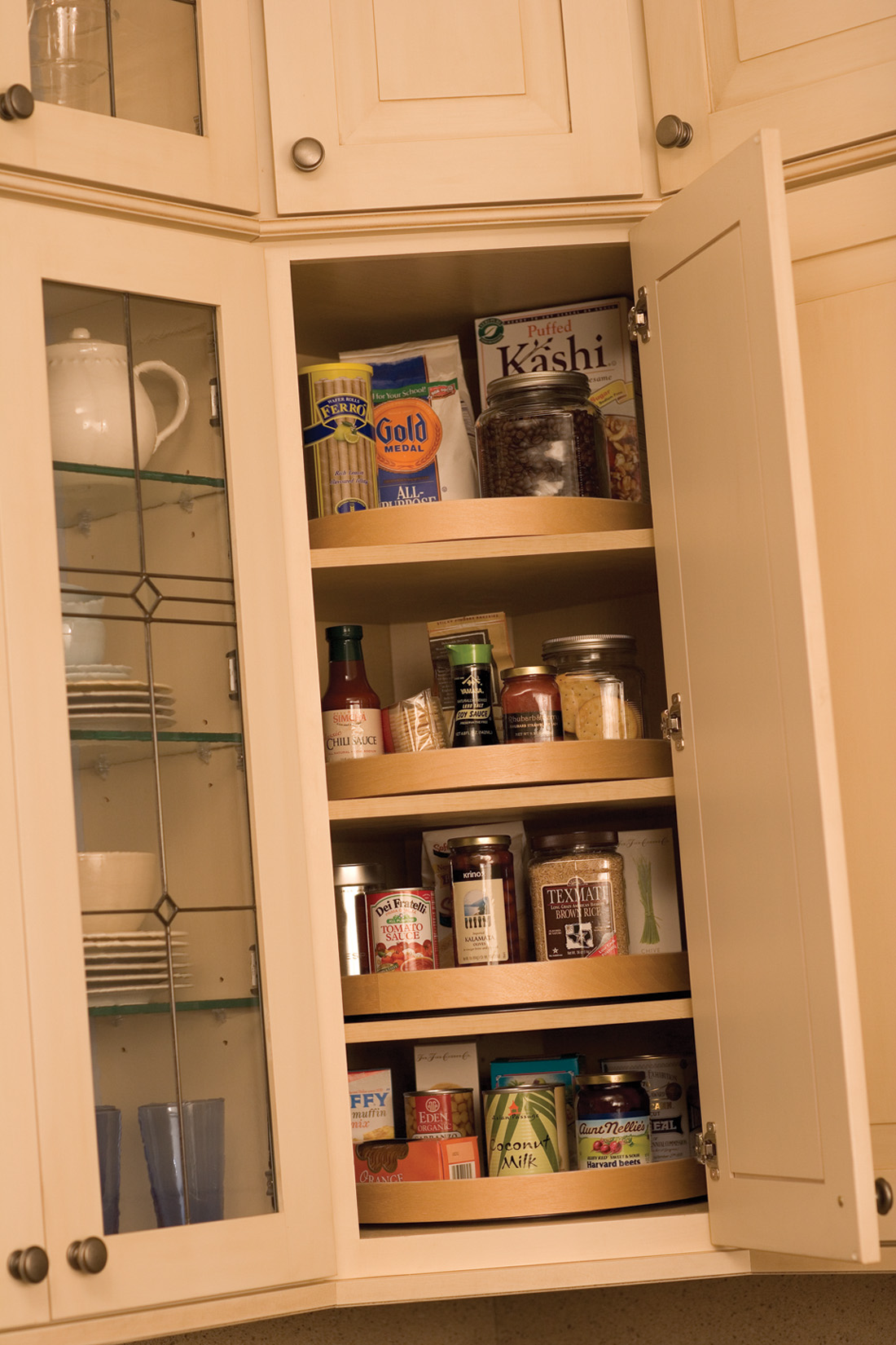 Kitchen Corner Cabinet Storage Ideas from Dura Supreme Cabinetry. A corner lazy susan in a wall cabinet.
