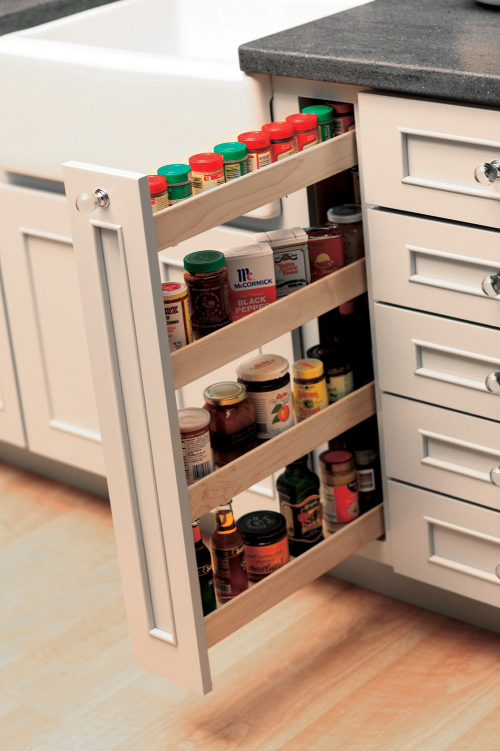 Small spaces offer a surprising amount of spice storage with a vertical Pull-Out Spice Rack. Kitchen Storage idea for spices and small pantry items from Dura Supreme Cabinetry.