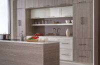 A modern textured kitchen design with a shiplap detail wrapping the kitchen island.