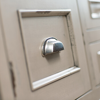 An inset cabinet door style with a distressed painted finish crafted by a finish artisan at Dura Supreme Cabinetry.