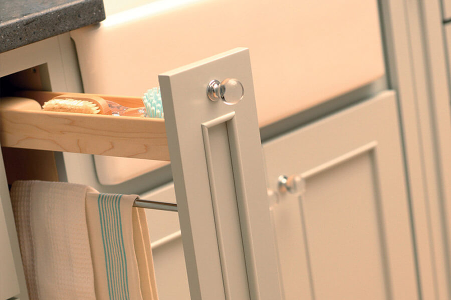 A cabinet storage solution next to the kitchen sink for hiding the kitchen town, sponges, and other cleaning supplies. his zone is dedicated to the care and clean-up of items that are used during the cooking process and after a meal.