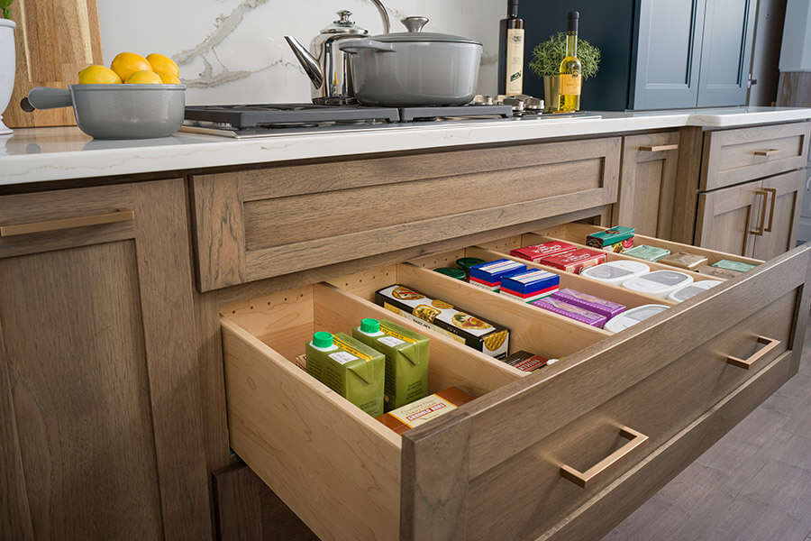 A deep kitchen drawer with partitions for organized pantry storage. While the external details are what will garner years of admiration from family and friends, it’s the internal accessories of your cabinetry that will make you smile each and every day. Learn how to plan the storage for your new kitchen design & remodel.