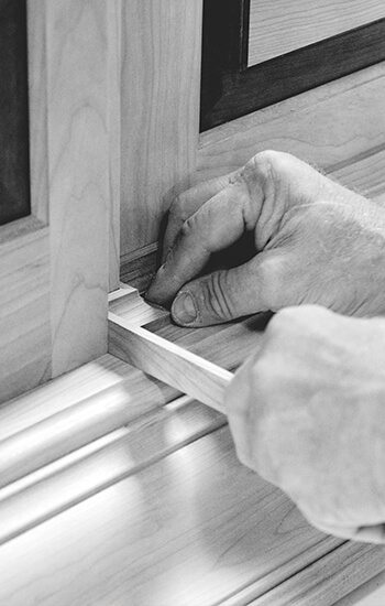 A close up of a cabinet maker working on the molding details of a custom cabinet. For over 60 years, a tireless dedication to excellence has defined Dura Supreme cabinetry and our core business values. We have built our reputation on a foundation of quality — solid construction, precision joinery, sound design, craftsmanship, and service.