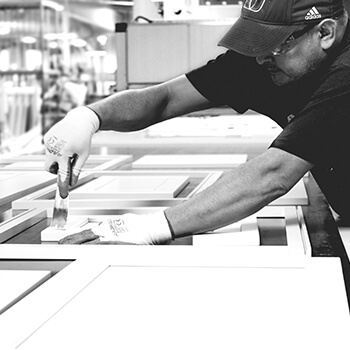 A finish worker detailing a cabinet to prepare it for a fresh finish coat. Learn more about what custom cabinetry truly means and the difference a factory finish can make in turning your home into a one-of-a-kind space.