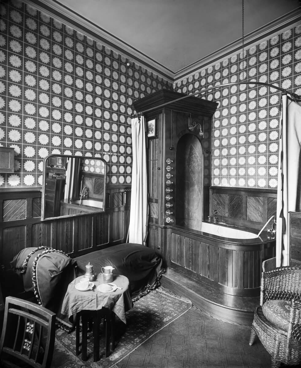 Victorian-Era bathroom furnished in wood, carpet and upholstered furniture