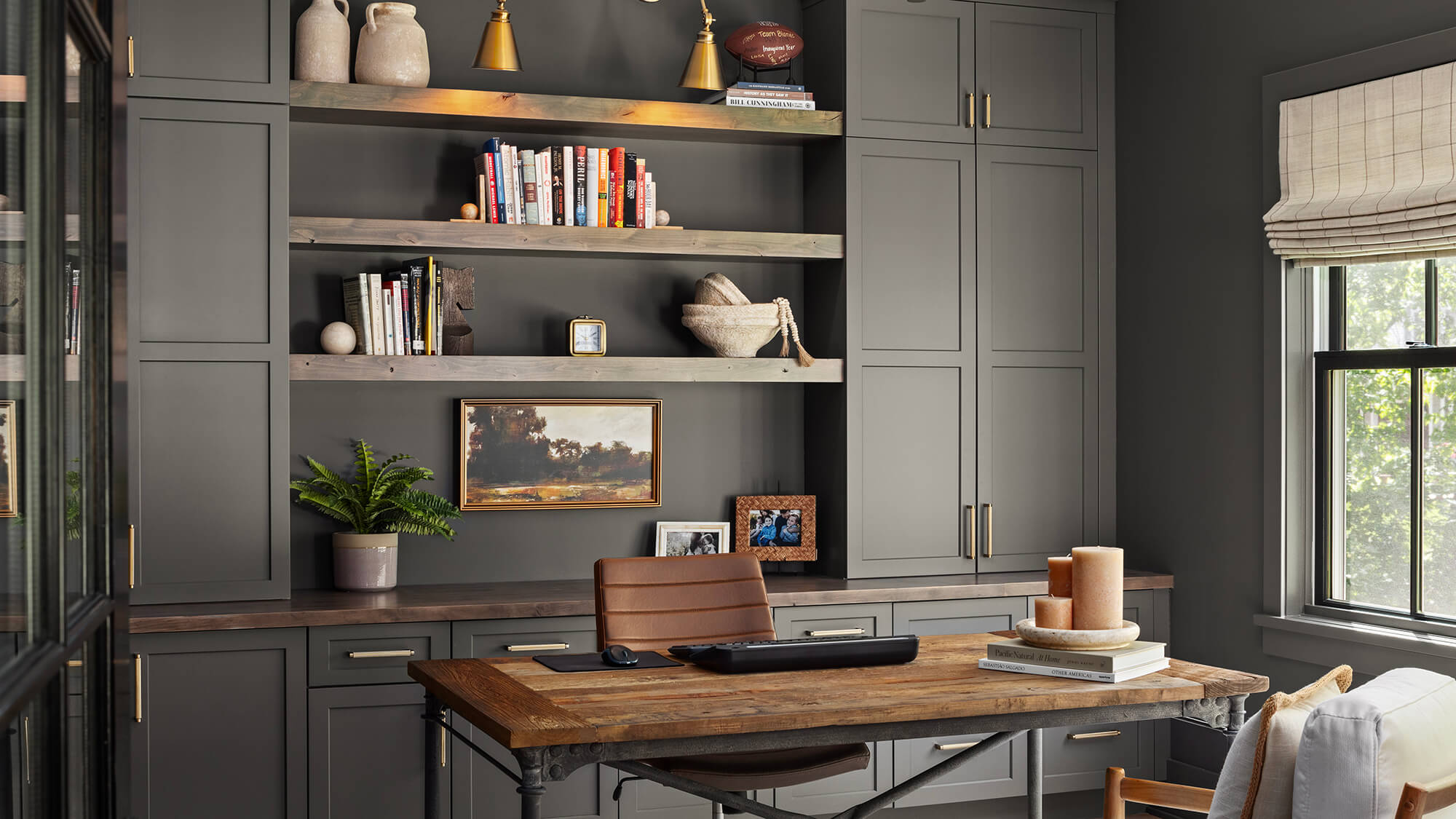 A dark army green home office design with true-brown stained wood accents.