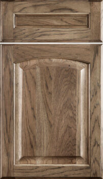 Hampton Classic is a traditional raised panel door with an arched raised panel. Shown in a Hickory wood with a medium true-brown stain color.