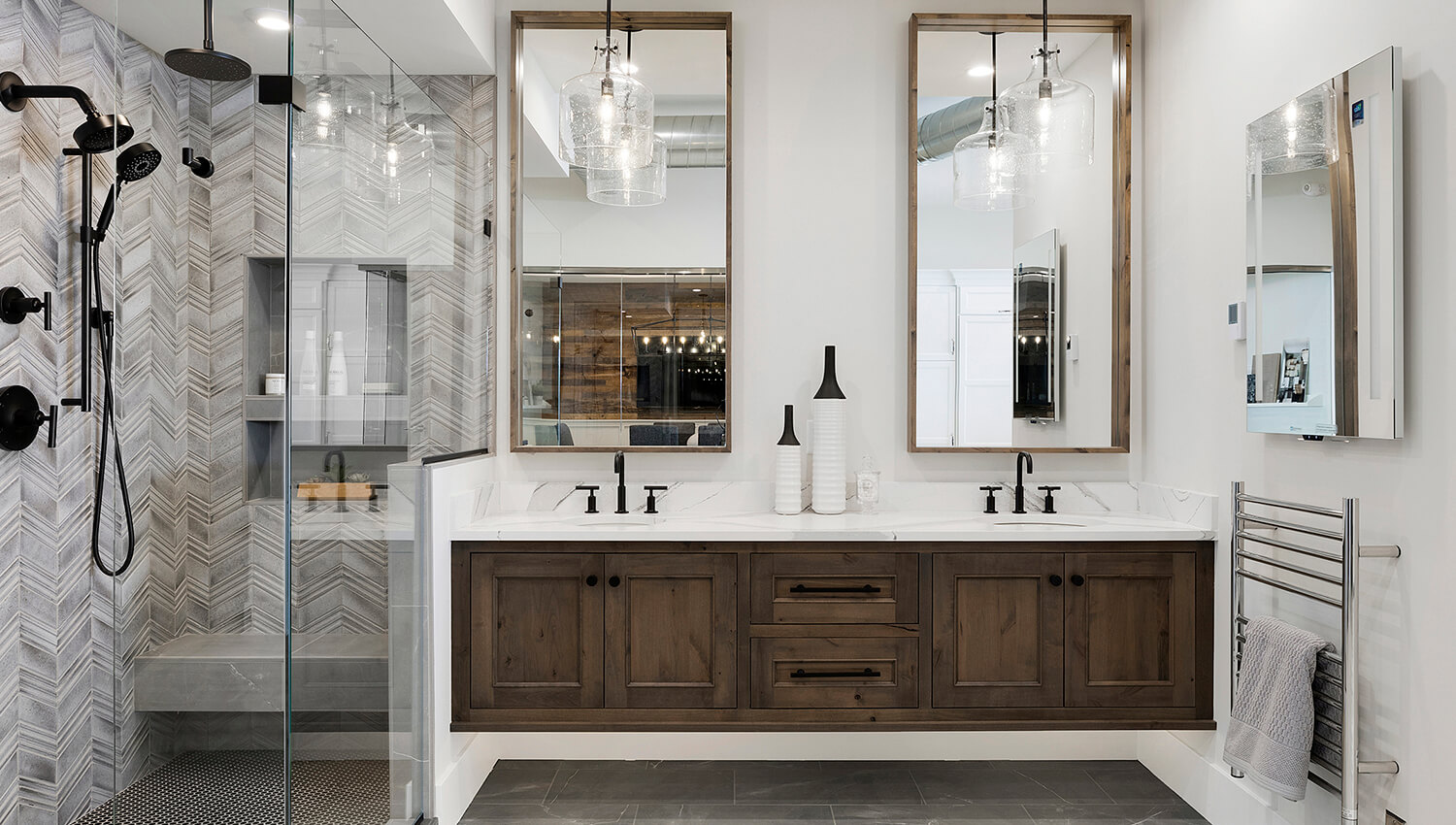 A transitional styled master bathroom with a floating vanity featuring two sinks and a dark, true-brown stain color on knotty alder cabinets.