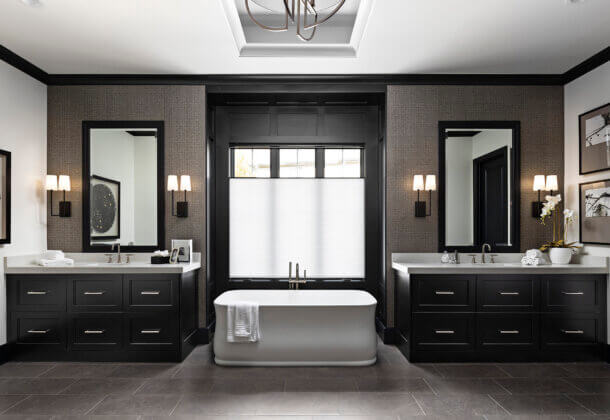 A Black & White master bathroom design with two modern black painted vanities.
