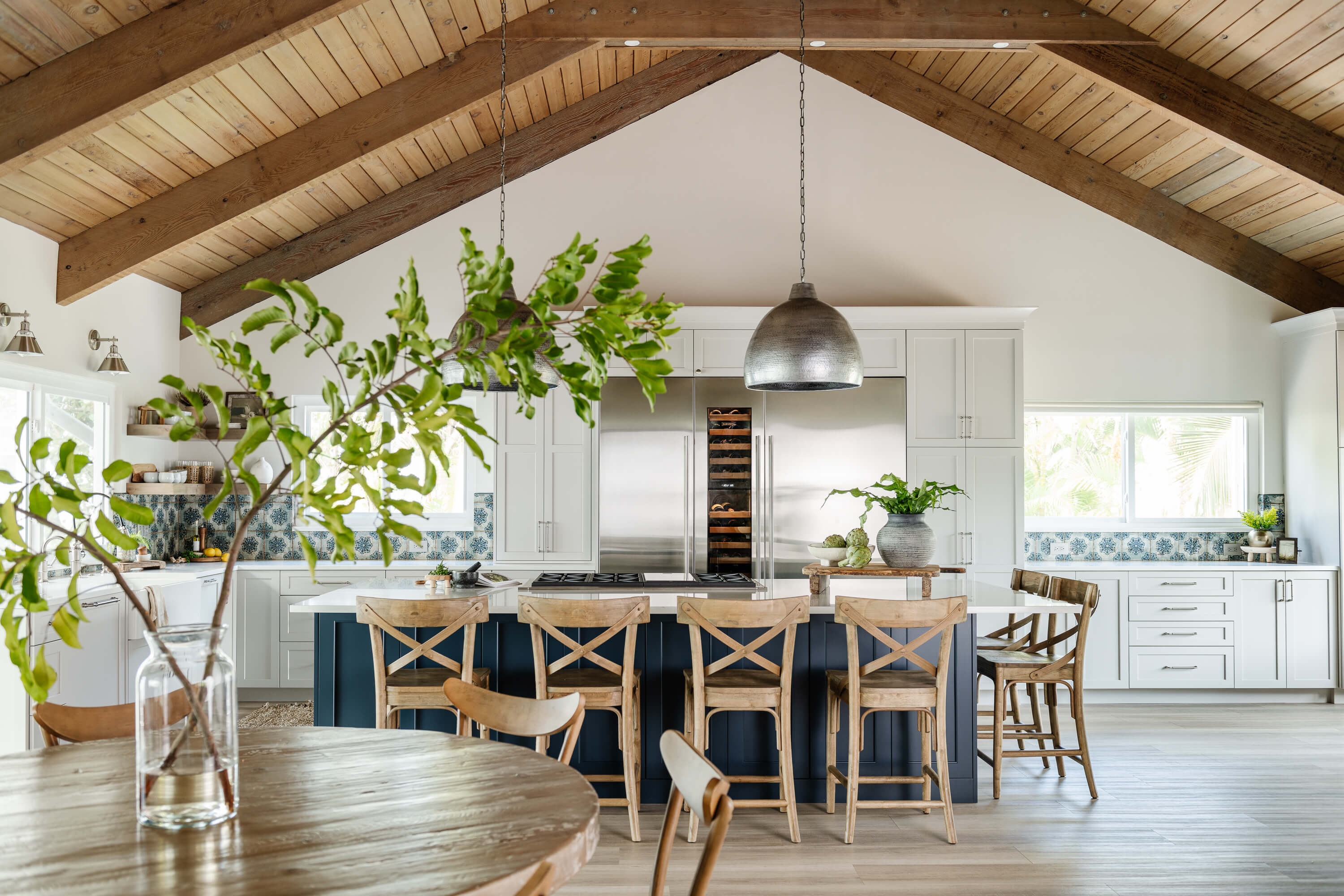 A stunning modern farmhouse kitchen design with two-toned cabinets in white and navy blue painted finishes.