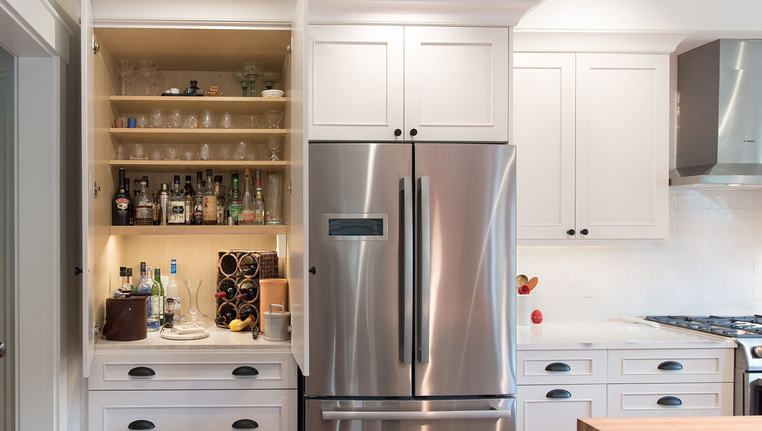 A liquor larder cabinet with organized storage.