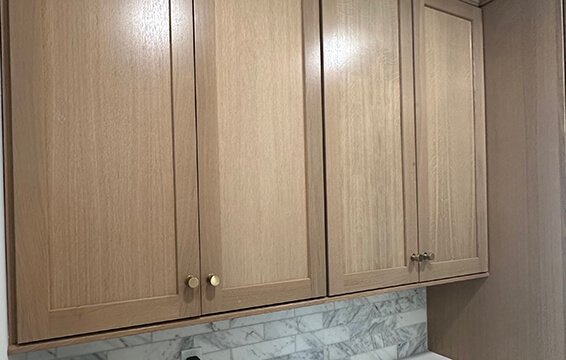 A close up of shaker cabinets with a stained finish from Dura Supreme Cabinetry.
