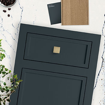 A trendy design concept for a kitchen design with a dark blue-green cabinet door with a skinny shaker style and light white oak stain.