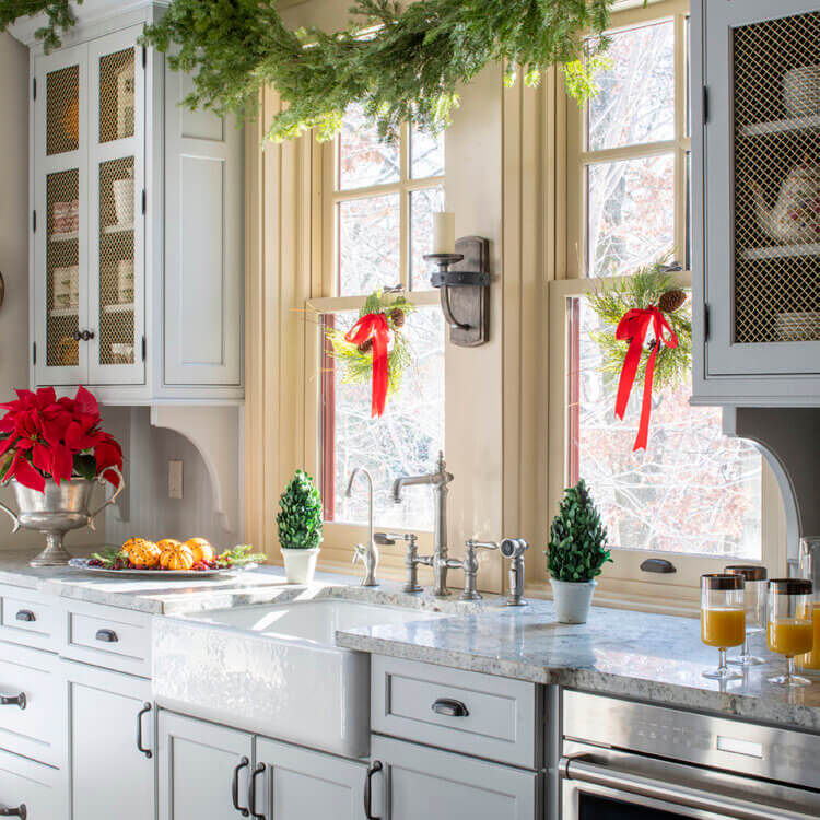 My Favorite Things for cabinetry. A kitchen sink area of a kitchen decorated for the holidays.