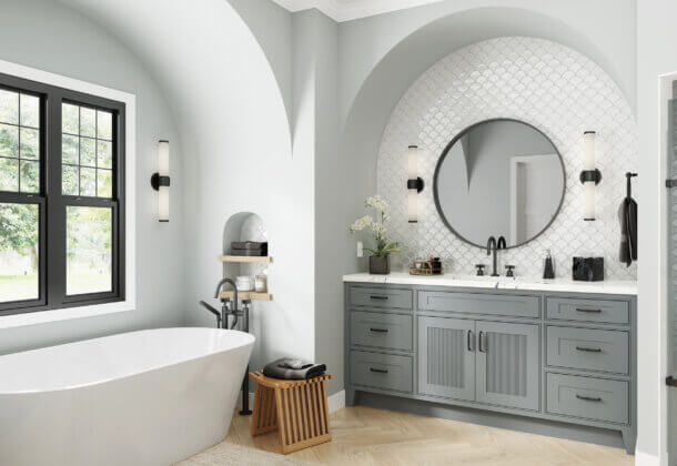 A classy bathroom design with reeded cabinet doors on the vanity and a free standing bath tub.
