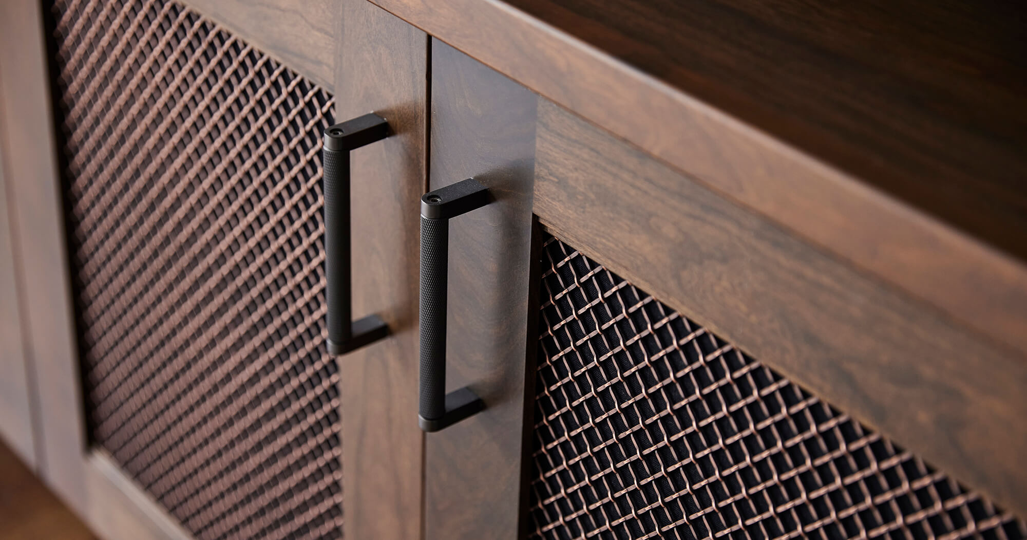 Metal Wire Mesh insert on a cabinet in an entertainment center to help electronic equipment breathe.