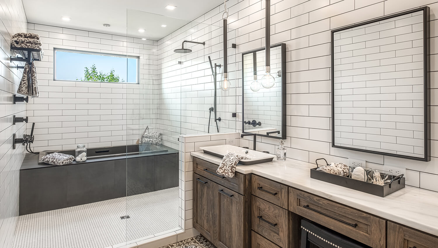 An industrial style bathroom with a black and white color palette using dark weathered wood on the vanity.