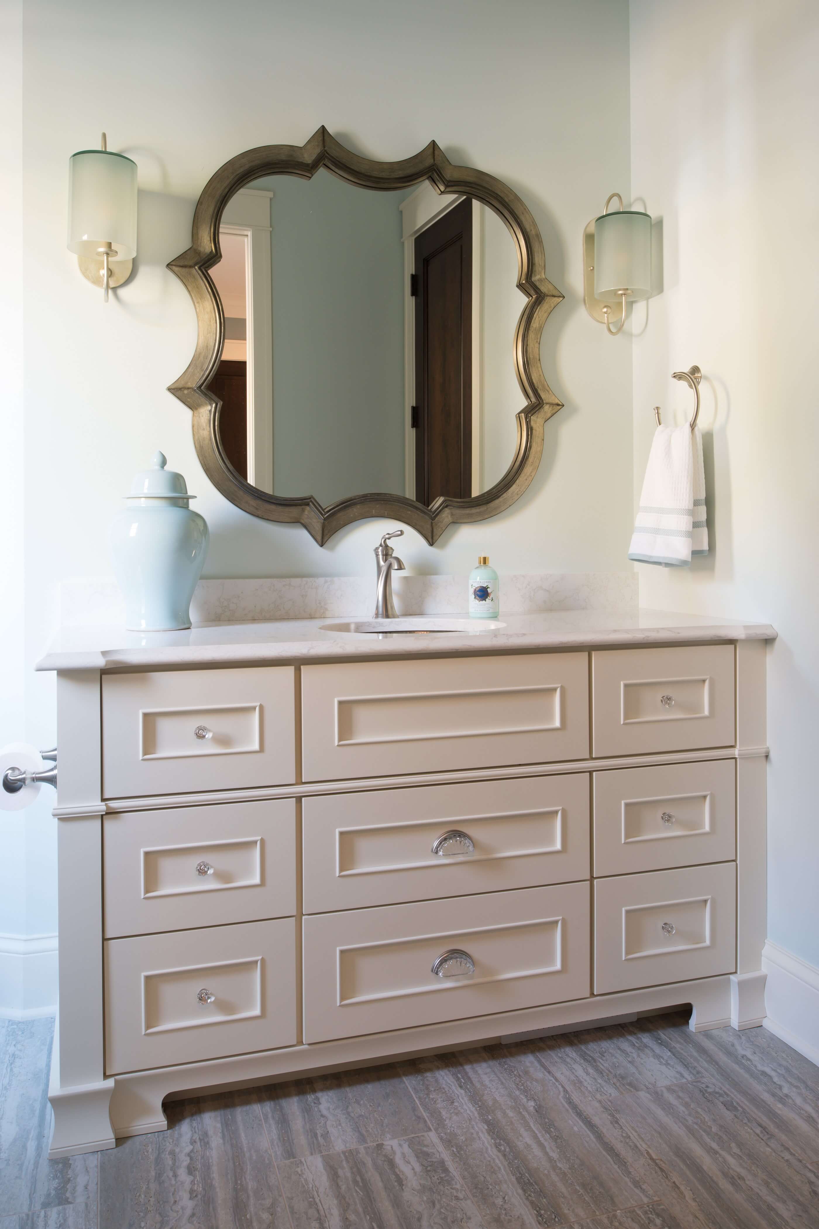 A traditional bathroom with an elegantly styled vanity with furniture inspired details.