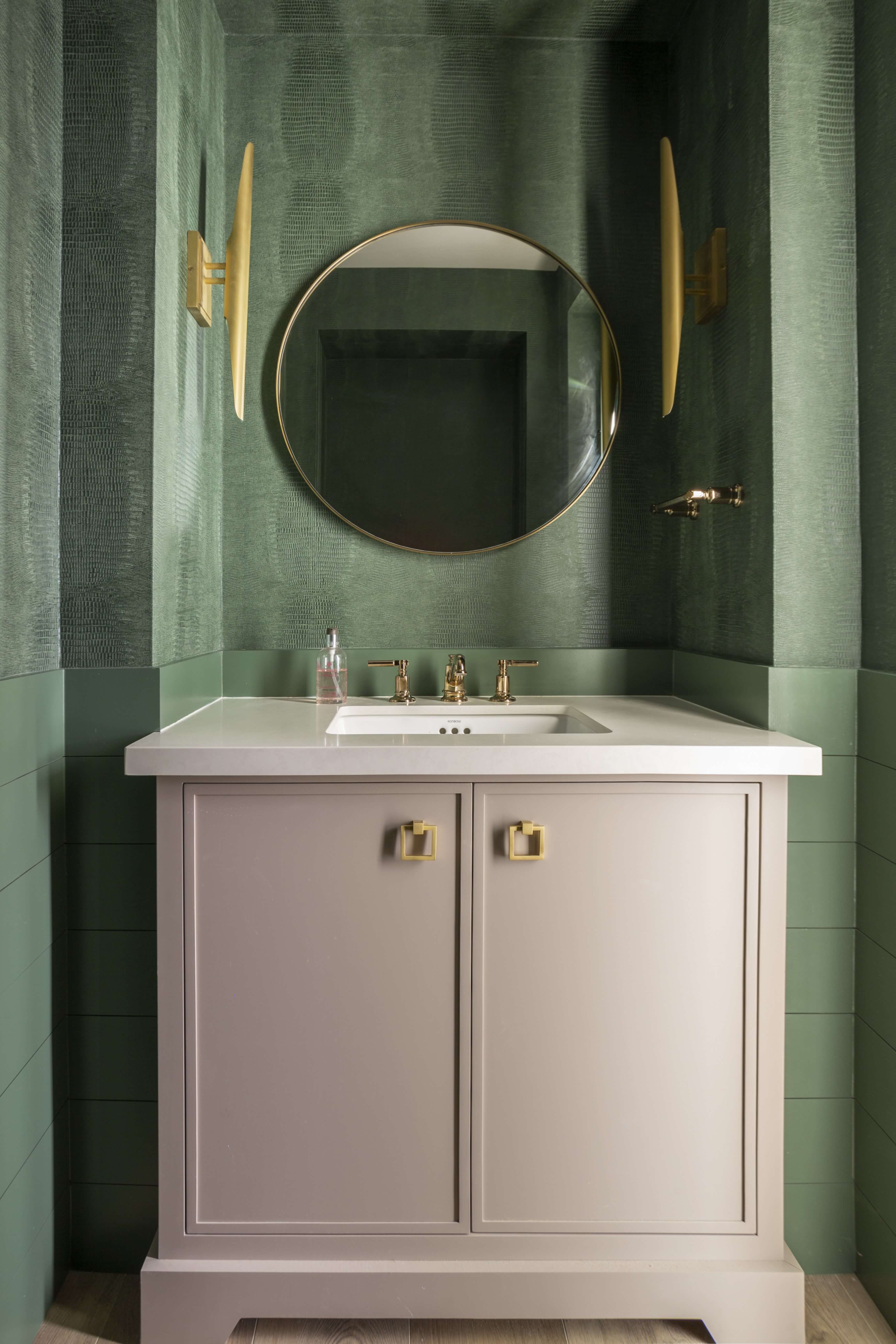 An off-white, beige furniture style vanity with custom details from Dura Supreme Cabinetry.