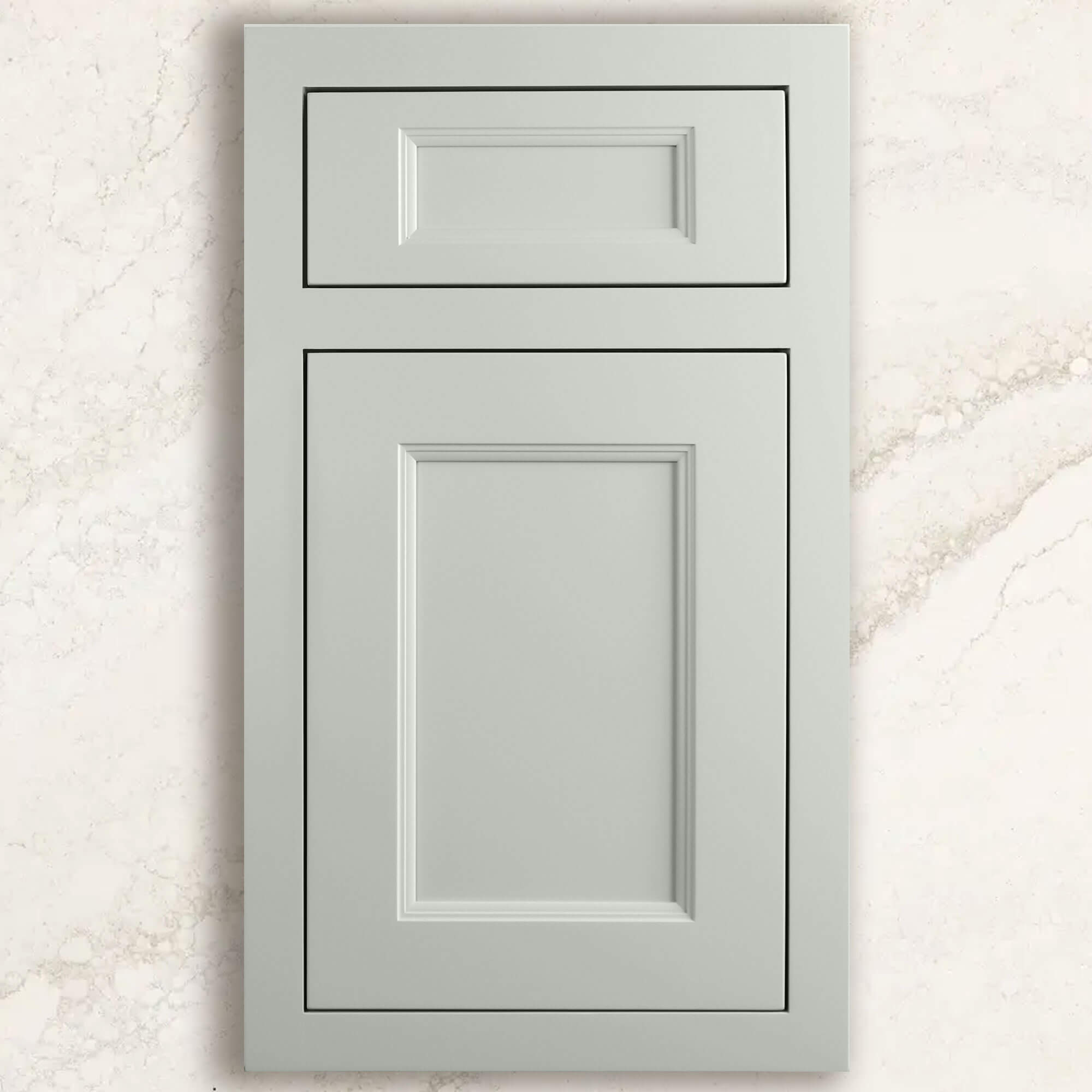 A light gray, off-white painted inset cabinet door with beautiful detailing and on-trend styling from Dura Supreme shown on top of a white/gray quartz countertop from Cambria.