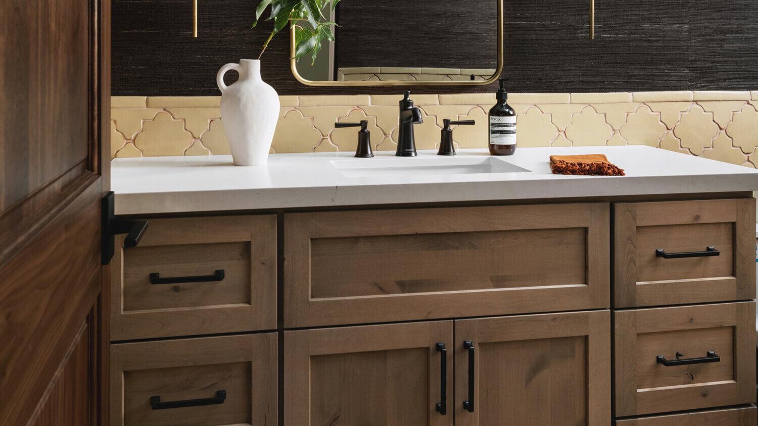 With an emphasis on comfort, heritage-inspired details, and lived-in textures, this master bathroom is a Mediterranean oasis. This stunning master suite features Dura Supreme’s Hudson shaker door style in the “Cashew” stain on Knotty Alder.