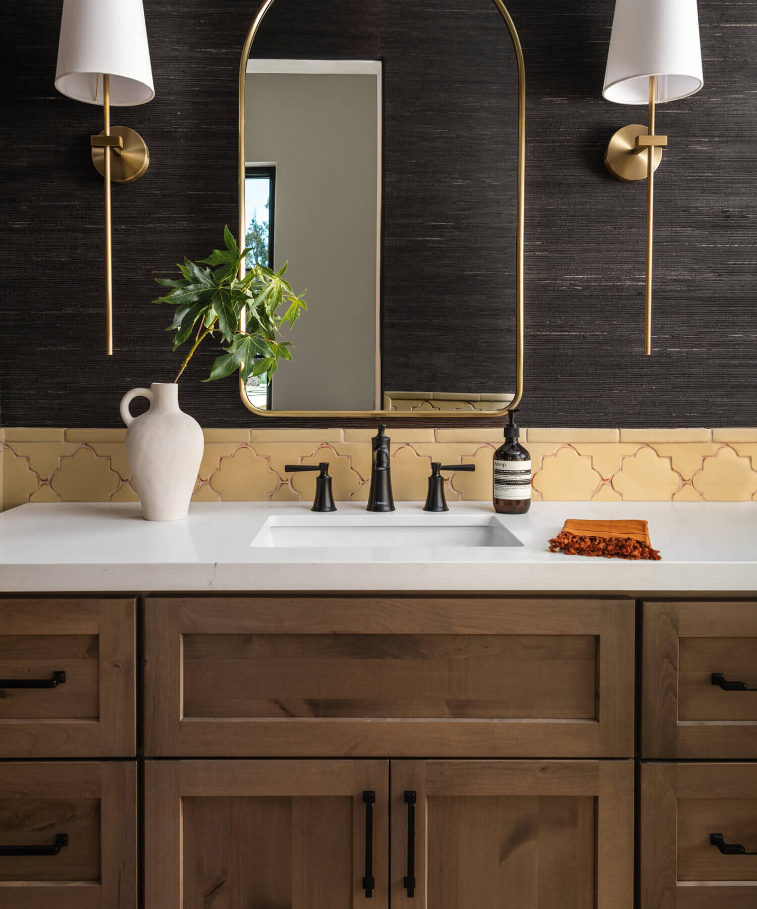 With an emphasis on comfort, heritage-inspired details, and lived-in textures, this master bathroom is a Mediterranean oasis. This stunning master suite features Dura Supreme’s Hudson shaker door style in the “Cashew” stain on Knotty Alder.