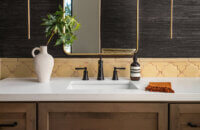 With an emphasis on comfort, heritage-inspired details, and lived-in textures, this master bathroom is a Mediterranean oasis. This stunning master suite features Dura Supreme’s Hudson shaker door style in the “Cashew” stain on Knotty Alder.