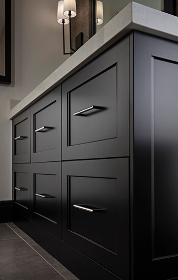 A close up of high quality custom cabinets with a black painted factory finish.